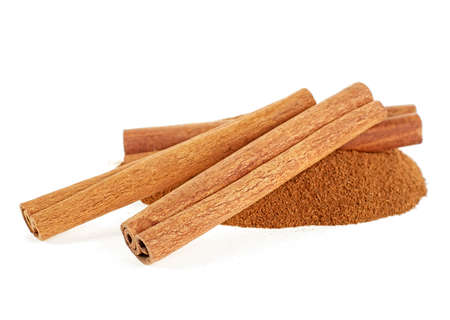 Heap of ground cinnamon and cinnamon sticks isolated on a white background. Cassia.の写真素材