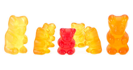 Yellow gummy bears and a single red one on a white background. Children's multivitamin.の写真素材