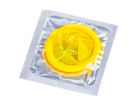 Yellow latex condom isolated on a white background. Condom safe sex concept.の写真素材