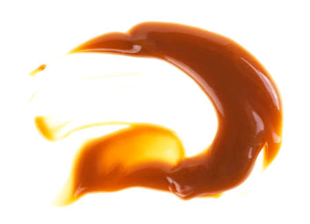 Caramel sauce isolated on a white backgroundの写真素材