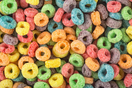 Background of round colorful cereal. Colorful breakfast food. Colorful cereal loop rings.の写真素材