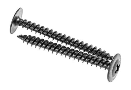 Two black screws isolated on a white background, selective focus.の写真素材