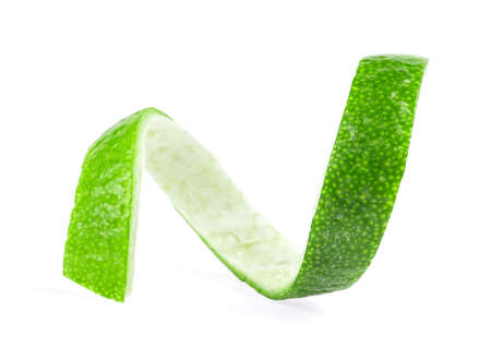 Green lemon twist isolated on a white background. Fresh lime peel.の写真素材