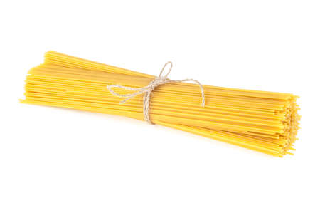 Bunch of spaghetti tied with rope isolated on a white background. Sheaf raw spaghetti.の写真素材