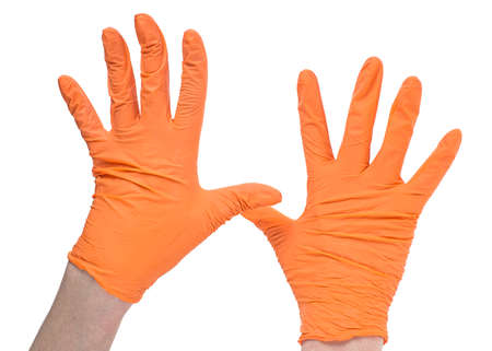 Medical gloves. Hands of a medic wearing a orange latex gloves. Surgical glove. Covid-19 prevention concept.の写真素材