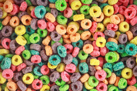 Background of round colorful cereal. Colorful breakfast food. Colorful cereal loop rings.の写真素材