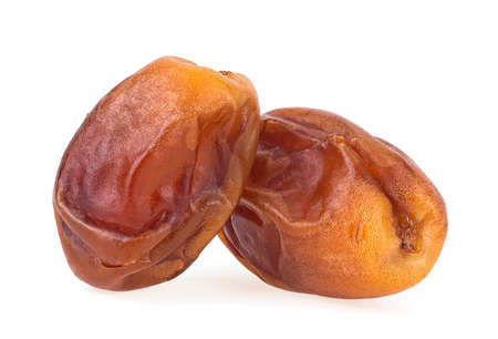 Dried sweet dates isolated on a white background. Date palm fruit isolated. Healthy food.の写真素材
