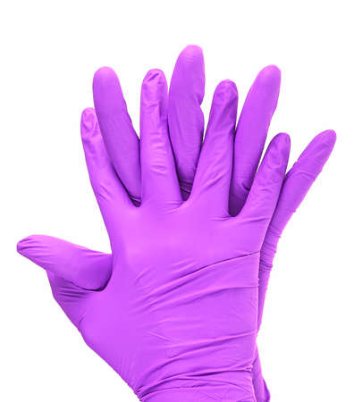 Hands of a medic wearing a violet latex gloves, white background.の写真素材