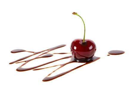 Red ripe cherry in liquid chocolate isolated on a white background. Fondue cherry in hot chocolate.の写真素材