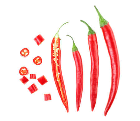 Top view of red chili peppers with slices on a white backgroundの写真素材