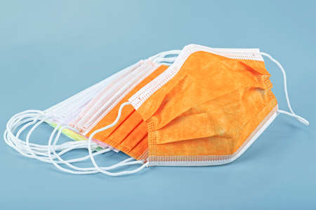Protection concept - Colorful medical masks isolated on gray background. Surgical mask with rubber ear straps.の写真素材