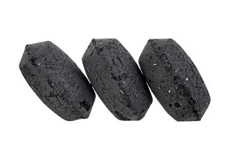 Coal briquette for BBQ isolated on a white background. Charcoal briquettes.の写真素材