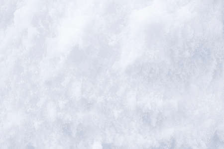 Background of fresh snow texture. Winter texture. Snowy white texture. Snowflakes.の写真素材
