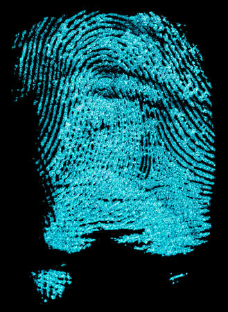 Fingerprint with ultraviolet lamp. Fingerprint on a black background. Concept of crime scene.の写真素材