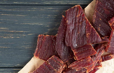 Beef jerky on a wooden board, top view. Sliced ââbeef jerky.の写真素材