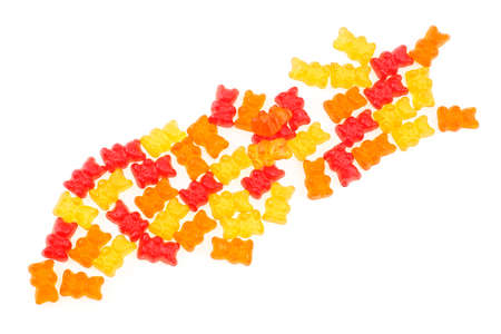 Top view of colorful eat gummy bears jelly candy isolated on a white background. Delicious color jelly bears. Fruit flavored gummy bears.の写真素材