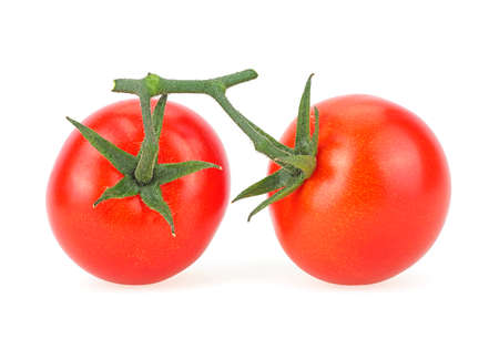Two ripe cherry tomatoes isolated on a white background. Two vegetables on branch with sepals.の写真素材