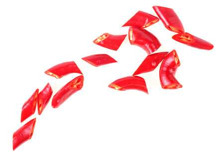 Red chopped chili peppers isolated on a white background, top view. Sliced red hot chili peppers.の写真素材