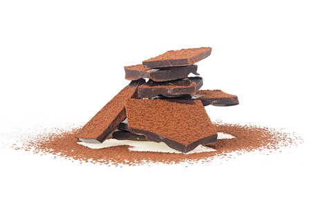 Chocolate bars with cocoa powder isolated on a white background. Heap of dark chocolate bars.の写真素材