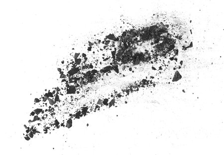 Black charcoal particles isolated on a white background, top view. Activated charcoal powder for facial mask. Black dust powder charcoal.の写真素材