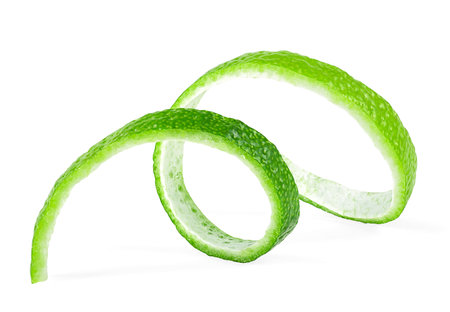 Fresh lime peel isolated on a white background, healthy food. Curly lime peel twist.の写真素材