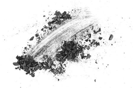 Black dust powder of charcoal on a white background, top view. Charcoal dust with fragments.の写真素材