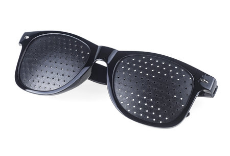 Black perforated glasses with holes isolated on a white background. Medical spectacles. Perforated glasses. Pinhole glasses. Training glasses.の写真素材