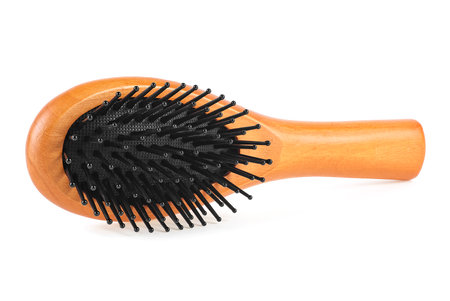Wooden comb brush isolated on a white backgroundの写真素材