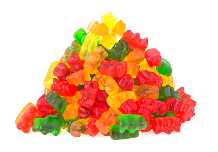 Close-up of delicious colorful gummy bears isolated on a white background. Pile of gummy bears candy.の写真素材