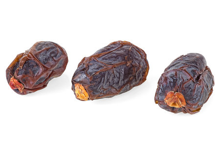 Ripe dried date fruits isolated on a white background. Organic and sweet dates. Healthy snack.の写真素材