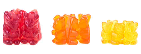Colorful eat gummy bears different sizes. Multicolored jelly bears candy isolated on a white background.の写真素材