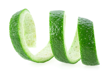 Fresh lime fruit peel isolated on a white background, healthy food. Curly lime peel twist. Cocktail ingredient.の写真素材