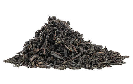 Dry black tea leaves isolated on a white background. Pile of black tea. Large leaf black tea.の写真素材