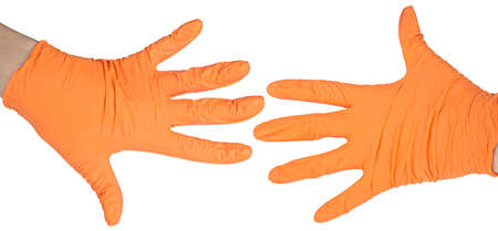 Hands of a medic wearing a medical latex gloves. Orange Surgical gloves.   prevention concept.の写真素材
