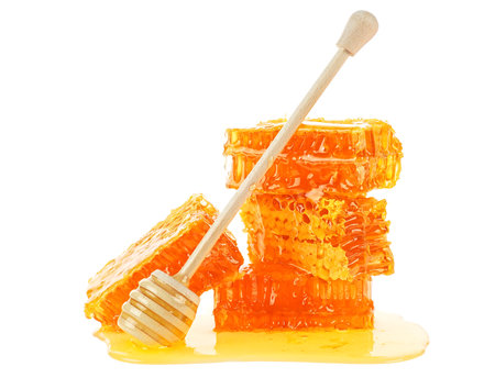 Honeycomb and honey dipper isolated on a white background. Yellow honeycomb slices.の写真素材