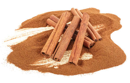 Aromatic cinnamon sticks and cinnamon powder isolated on a white background, selective focus.
