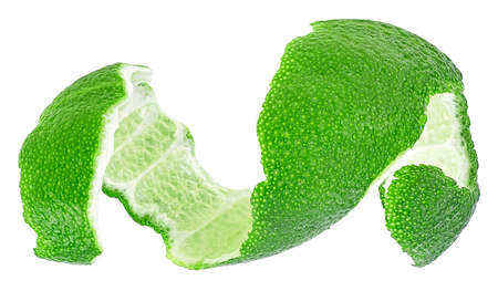 Peel of green citrus fruit isolated on a white background. Lime skin. Curly lime peel twist.の写真素材