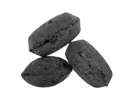 Coal briquette for BBQ isolated on a white background. Three black charcoal briquettes.の写真素材
