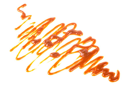 Sweet caramel sauce isolated on a white background. Liquid caramel. Toffee toppings.の写真素材