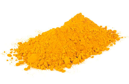 Turmeric powder pile isolated on a white background. Yellow curcuma powder. Indian spice.の写真素材
