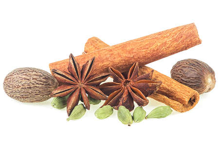 Various spices. Traditional Christmas spices - cinnamon sticks, star anise, nutmeg and cardamom pods isolated on a white background.の写真素材