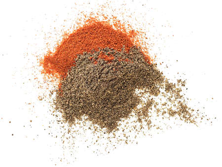Pile of red and black pepper powder isolated on a white background, top view.の写真素材