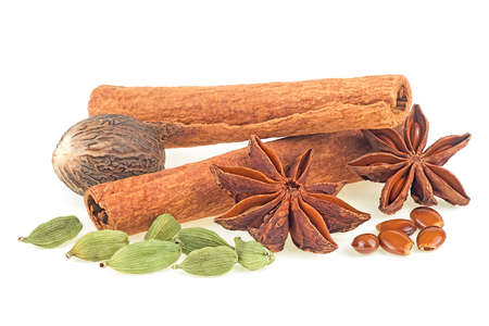 Traditional Christmas spices - cinnamon sticks, star anise, nutmeg and cardamom pods isolated on a white background.の写真素材