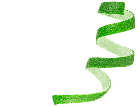 Zest of fresh ripe lime isolated on a white background. Lime twist, top view.の写真素材