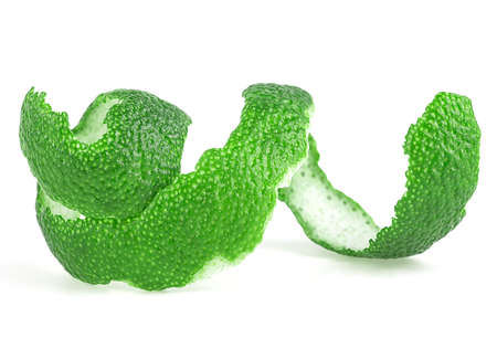 Lime zest spiral isolated on a white background. Peel of green lime.の写真素材