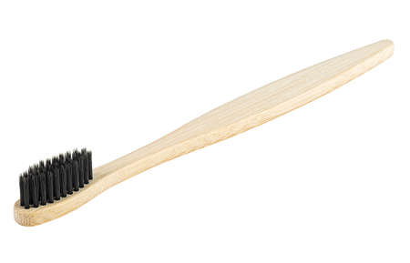 Bamboo wood toothbrush with black brush bristles isolated on a white background. Natural bamboo toothbrush.の写真素材