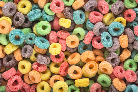 Background of round colorful cereal. Colorful breakfast food. Colorful cereal loop rings.の写真素材