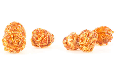 Delicious caramel popcorn isolated on a white background. Sweet caramel candy popcorn pieces.の写真素材