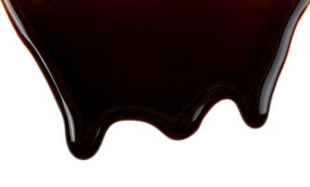 Chocolate streams isolated on a white background. Chocolate syrup. Melting chocolate drips.の写真素材