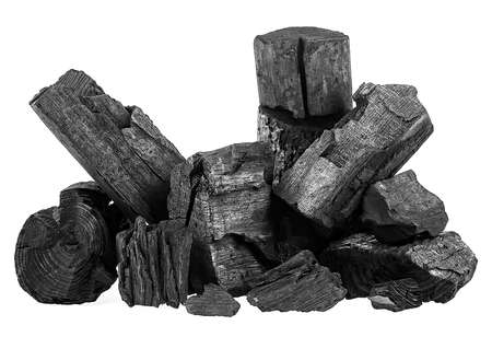 Pile of hardwood charcoal isolated on a white background. Natural wood charcoal.の写真素材